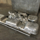 Recovered aluminium ingots after dross pressing cycle — end product of effective skim pan and dross press operation in aluminium casthouse